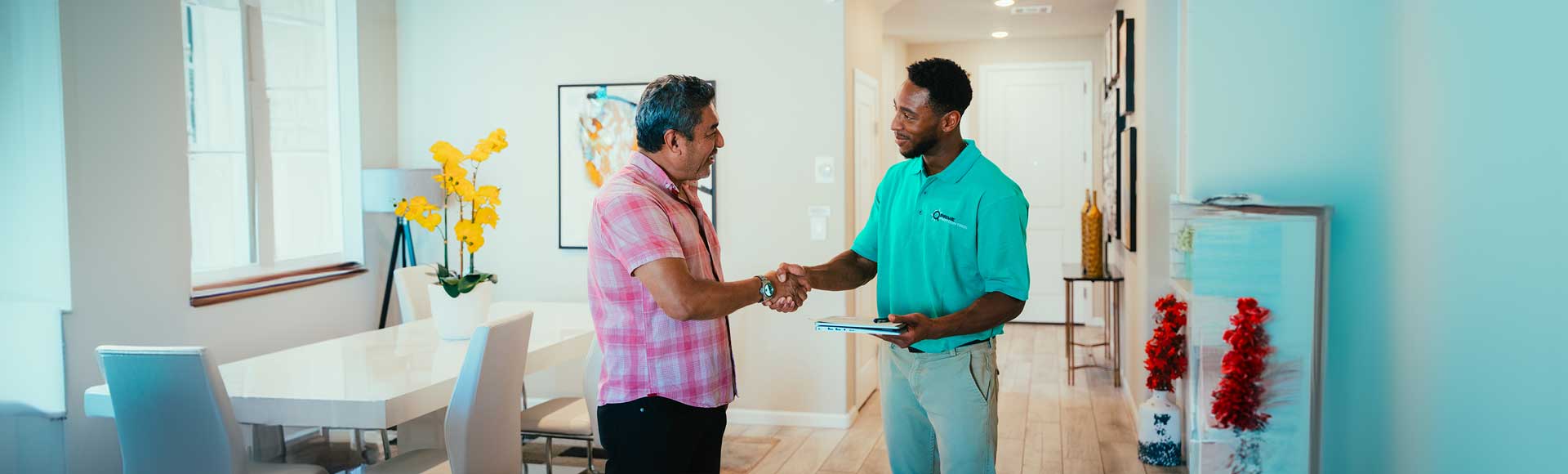 HVAC technician shaking hands with a homeowner in a modern living room